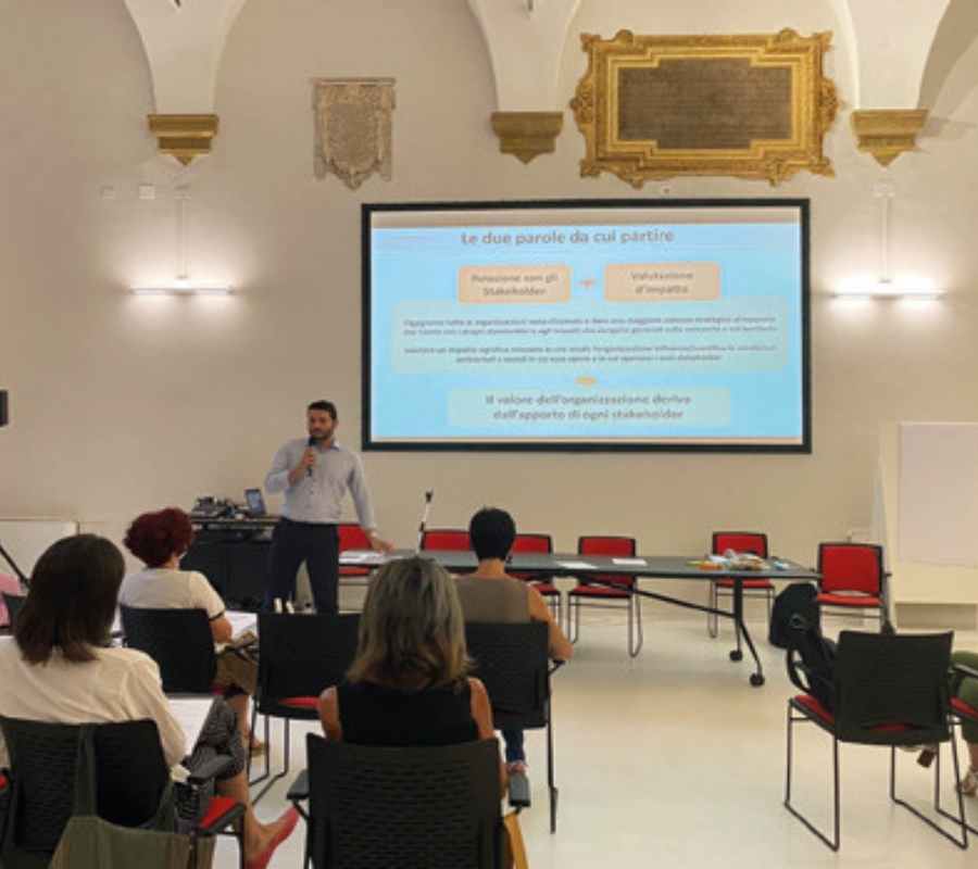 Gruppo eterogeneo di persone che collaborano attorno a un tavolo, dall'esperienza alla filiera
